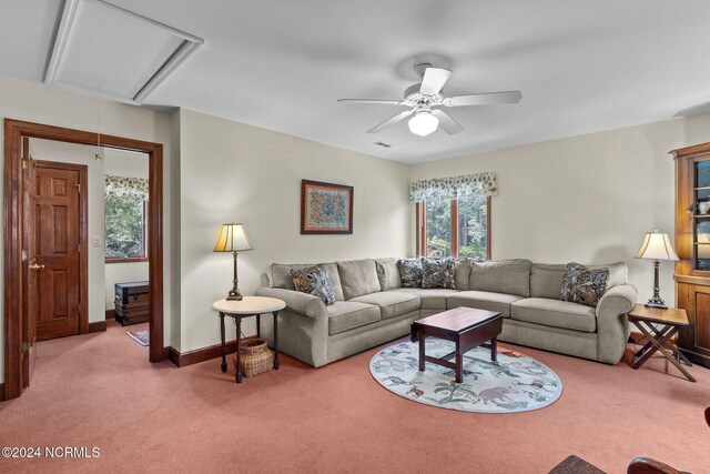 114 SW 21st St, Oak Island, NC 28465 - carpeted living room with attic access, visible vents, a ceiling fan, and baseboards