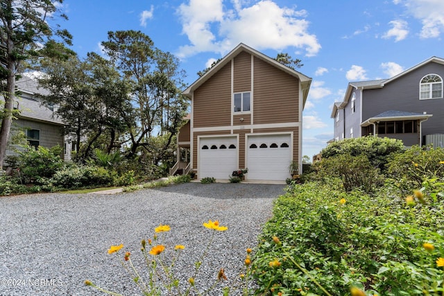 114 SW 21st St, Oak Island, NC 28465 - exterior space with gravel driveway and an attached garage