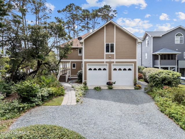 114 SW 21st St, Oak Island, NC 28465 - view of front facade featuring gravel driveway and an attached garage