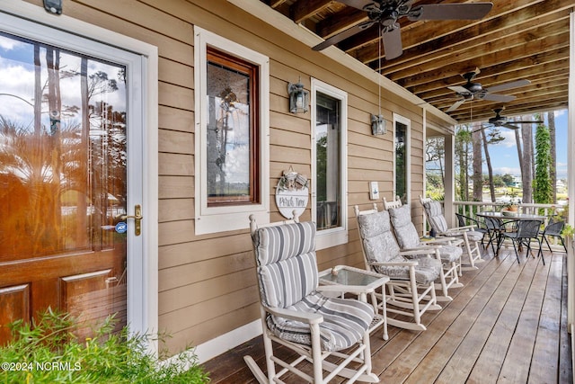 wooden deck featuring ceiling fan