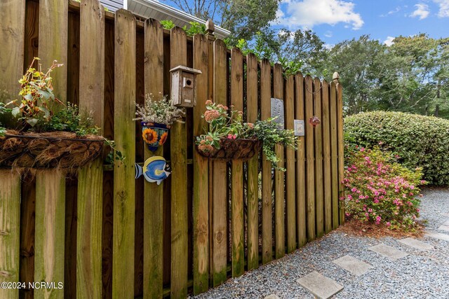 114 SW 21st St, Oak Island, NC 28465 - view of gate featuring fence