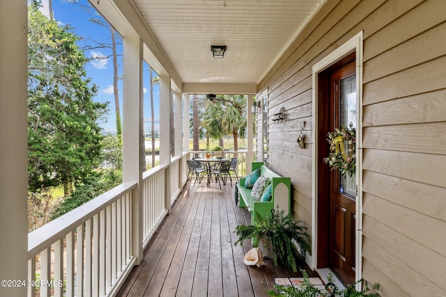 114 SW 21st St, Oak Island, NC 28465 - wooden terrace with outdoor dining area