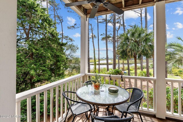114 SW 21st St, Oak Island, NC 28465 - balcony featuring a ceiling fan and a water view