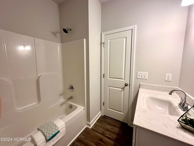 bathroom with vanity, wood-type flooring, and tub / shower combination