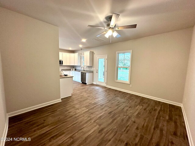 unfurnished living room with ceiling fan, dark hardwood / wood-style floors, and sink