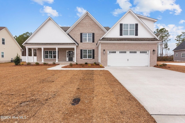 view of front of home featuring a porch and a garage