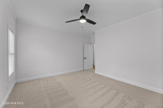 carpeted empty room featuring ceiling fan, plenty of natural light, and ornamental molding