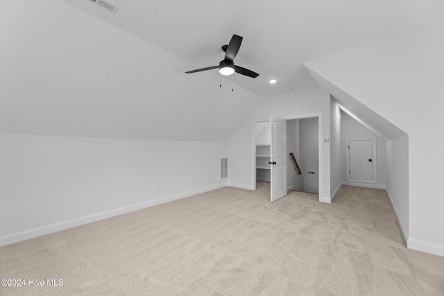 additional living space featuring ceiling fan, light colored carpet, and lofted ceiling