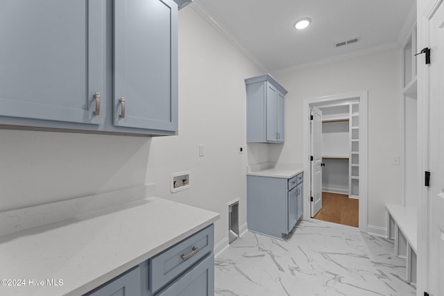 laundry area featuring electric dryer hookup, cabinets, ornamental molding, and hookup for a washing machine