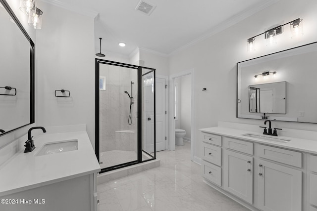 bathroom featuring vanity, toilet, a shower with door, and ornamental molding