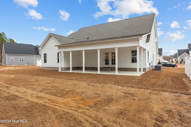 rear view of house featuring cooling unit and a patio