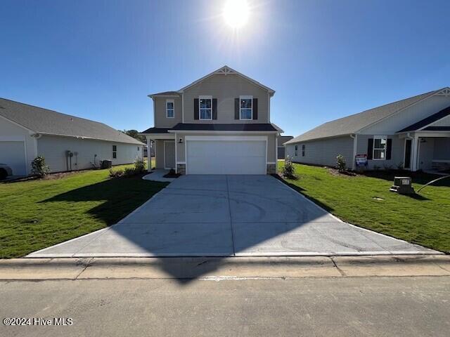 front facade with a front yard and a garage