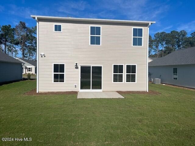 back of house featuring a patio area, central air condition unit, and a yard