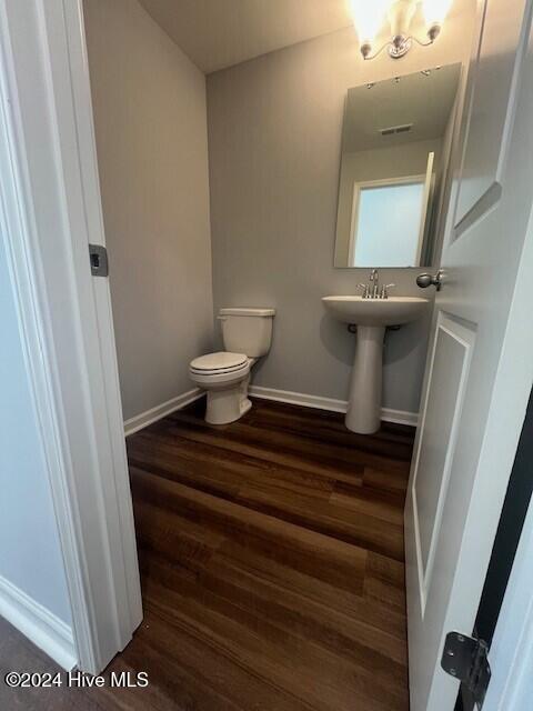 bathroom featuring sink, hardwood / wood-style floors, and toilet