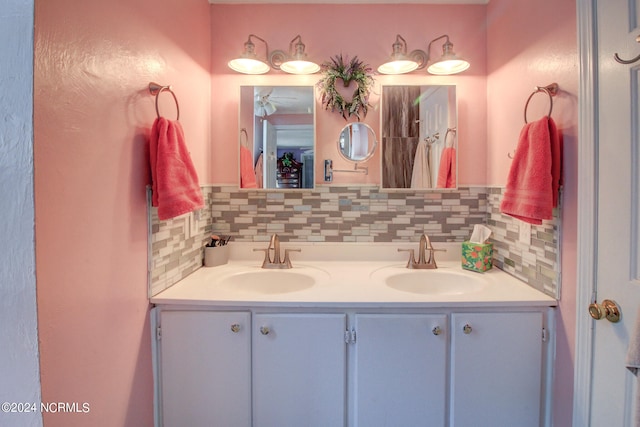 bathroom featuring vanity and tasteful backsplash