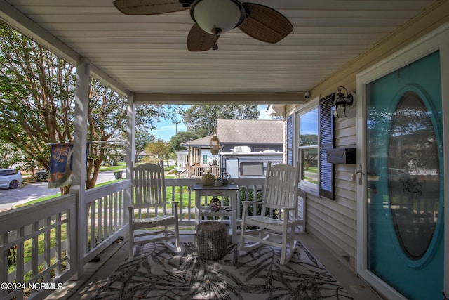 wooden terrace with a porch and ceiling fan