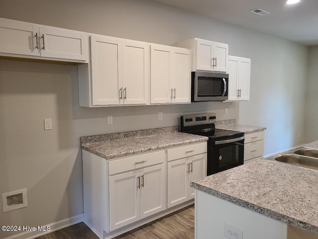 kitchen featuring white cabinetry, light hardwood / wood-style flooring, stainless steel appliances, and sink