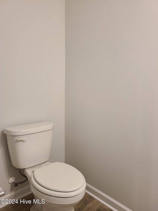 bathroom featuring toilet and wood-type flooring