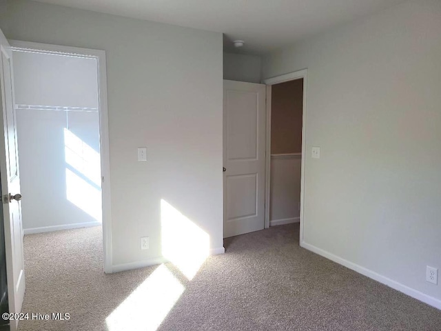 unfurnished room featuring light carpet