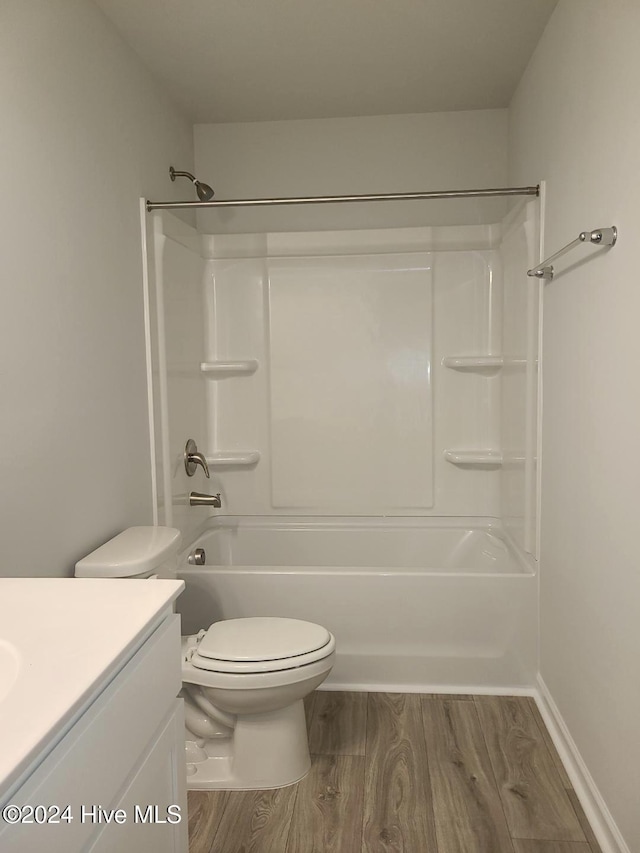 full bathroom featuring wood-type flooring, vanity, toilet, and shower / tub combination