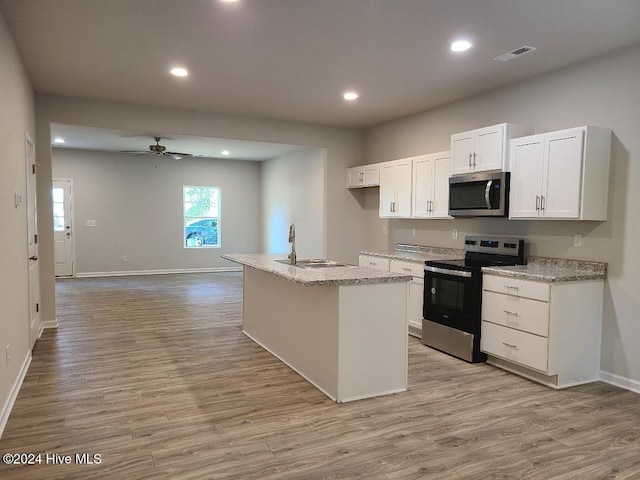 kitchen with sink, a center island with sink, white cabinets, and appliances with stainless steel finishes