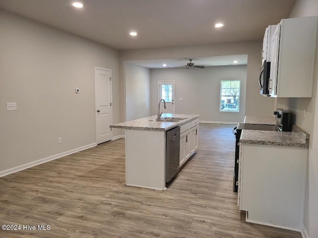 kitchen featuring appliances with stainless steel finishes, sink, light hardwood / wood-style flooring, white cabinets, and an island with sink