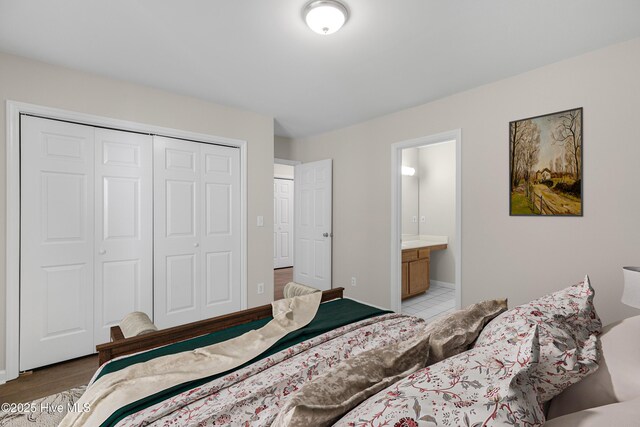 unfurnished bedroom featuring dark wood-type flooring and ensuite bathroom