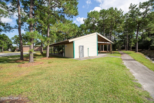 exterior space with a lawn and a carport