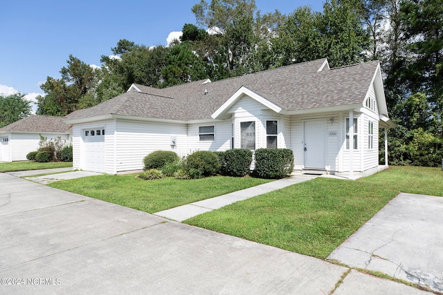 single story home featuring a front yard and a garage