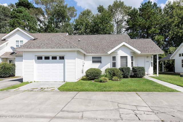 view of front of home featuring a front yard and a garage