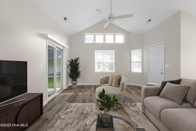 entrance foyer featuring vaulted ceiling, dark wood-type flooring, and a healthy amount of sunlight