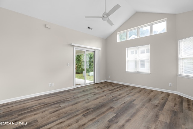 spare room featuring high vaulted ceiling, ceiling fan, dark wood-type flooring, and a wealth of natural light