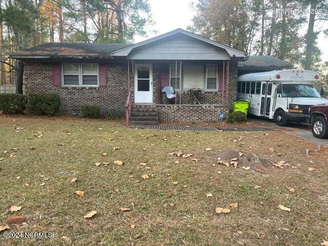 view of front of house featuring a front yard and covered porch