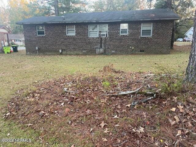 view of property exterior featuring a lawn