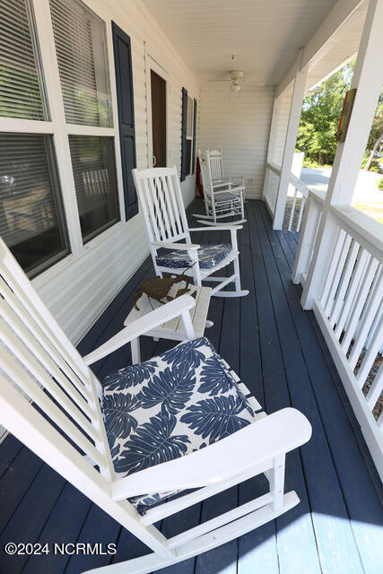 wooden terrace with ceiling fan and a porch