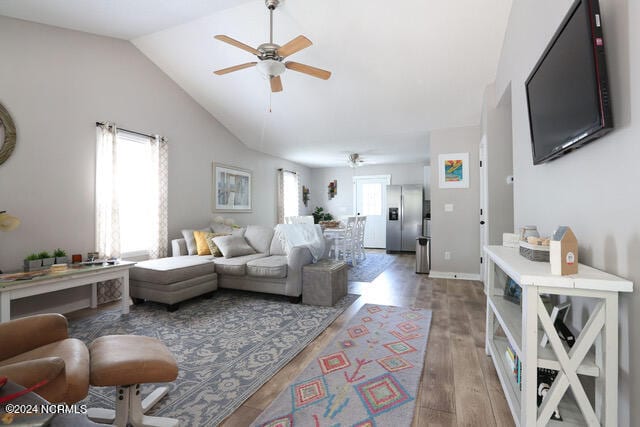 living room with vaulted ceiling, ceiling fan, and hardwood / wood-style floors