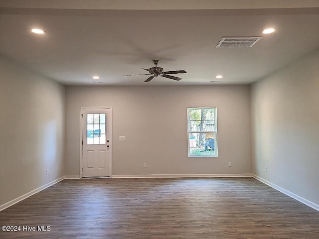 spare room featuring ceiling fan and dark hardwood / wood-style floors