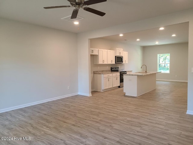 kitchen featuring white cabinetry, an island with sink, appliances with stainless steel finishes, and light hardwood / wood-style flooring