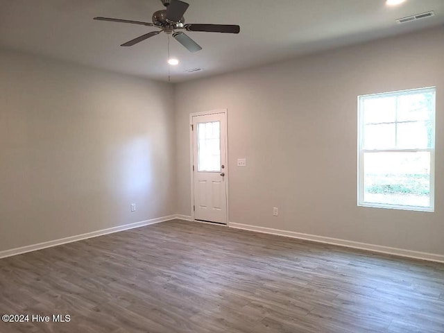 unfurnished room with ceiling fan and dark hardwood / wood-style floors