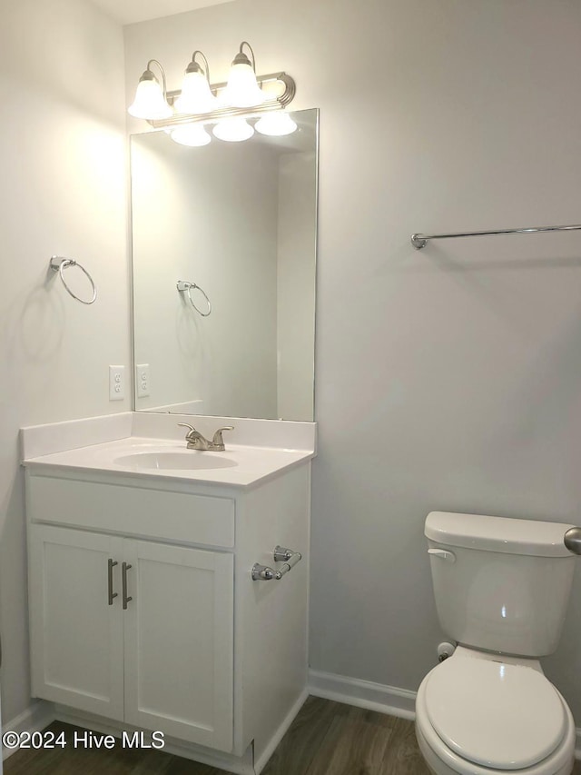 bathroom featuring hardwood / wood-style floors, vanity, and toilet