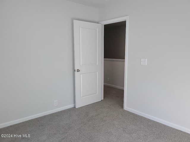 empty room with light colored carpet