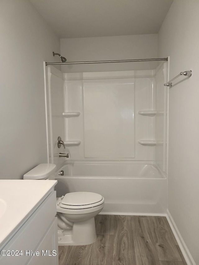 full bathroom featuring toilet, vanity, shower / bath combination, and hardwood / wood-style flooring