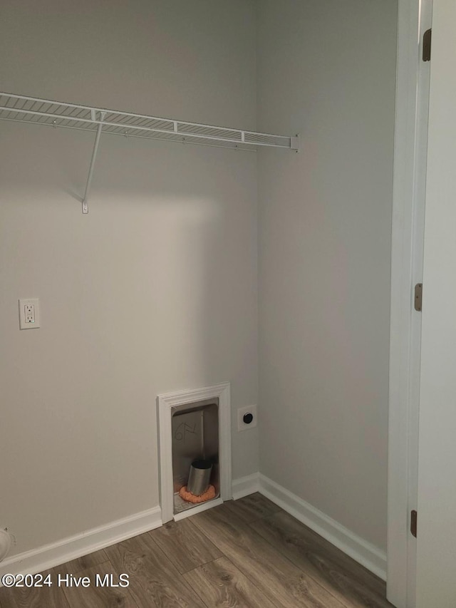 washroom featuring dark hardwood / wood-style flooring and electric dryer hookup