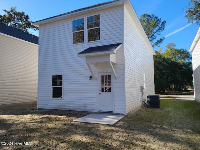 back of house featuring a yard and central AC unit