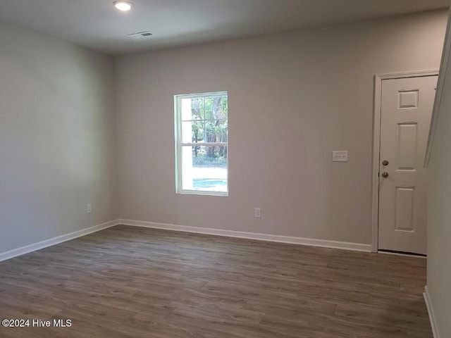 spare room featuring dark wood-type flooring