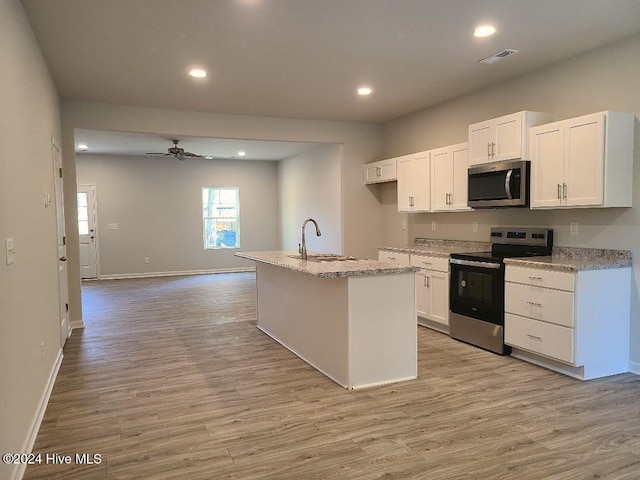 kitchen featuring white cabinets, sink, an island with sink, and stainless steel appliances