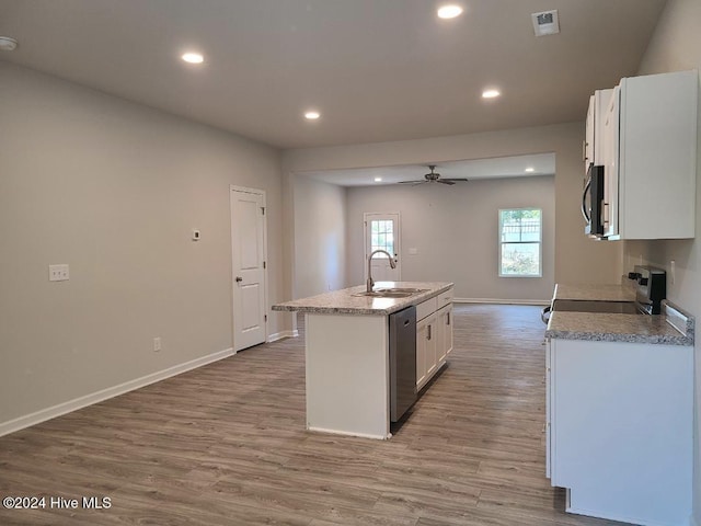 kitchen with sink, light hardwood / wood-style flooring, an island with sink, appliances with stainless steel finishes, and white cabinetry