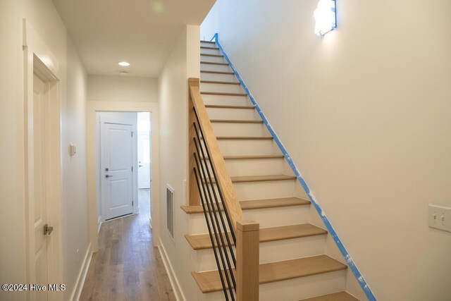 stairs with hardwood / wood-style flooring