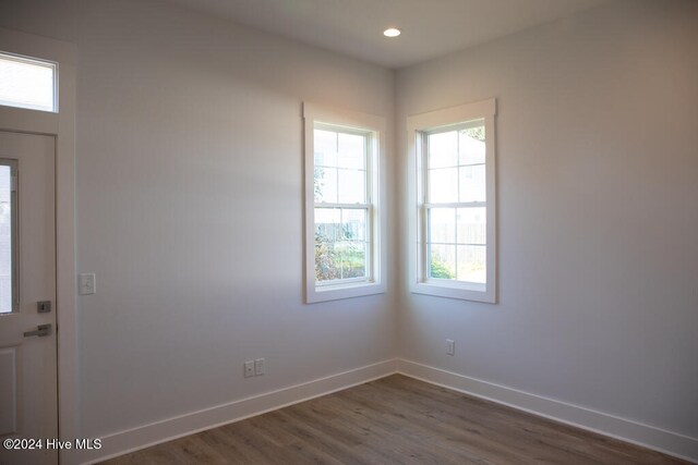 empty room with dark hardwood / wood-style flooring