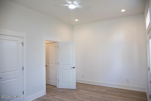 unfurnished bedroom featuring light wood-type flooring and ceiling fan